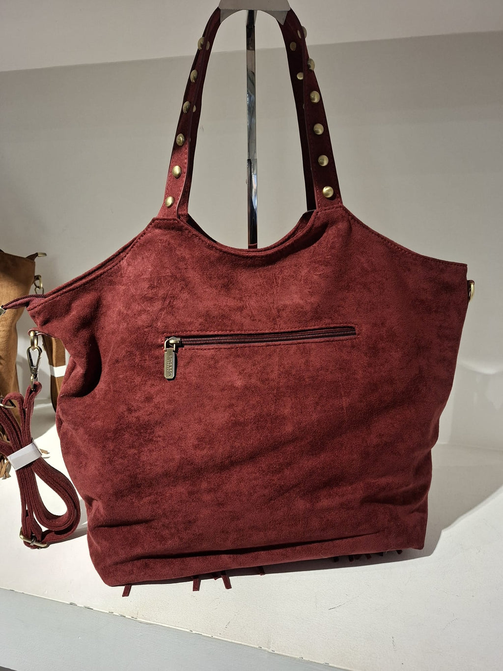 "Spacious burgundy handbag interior and design"