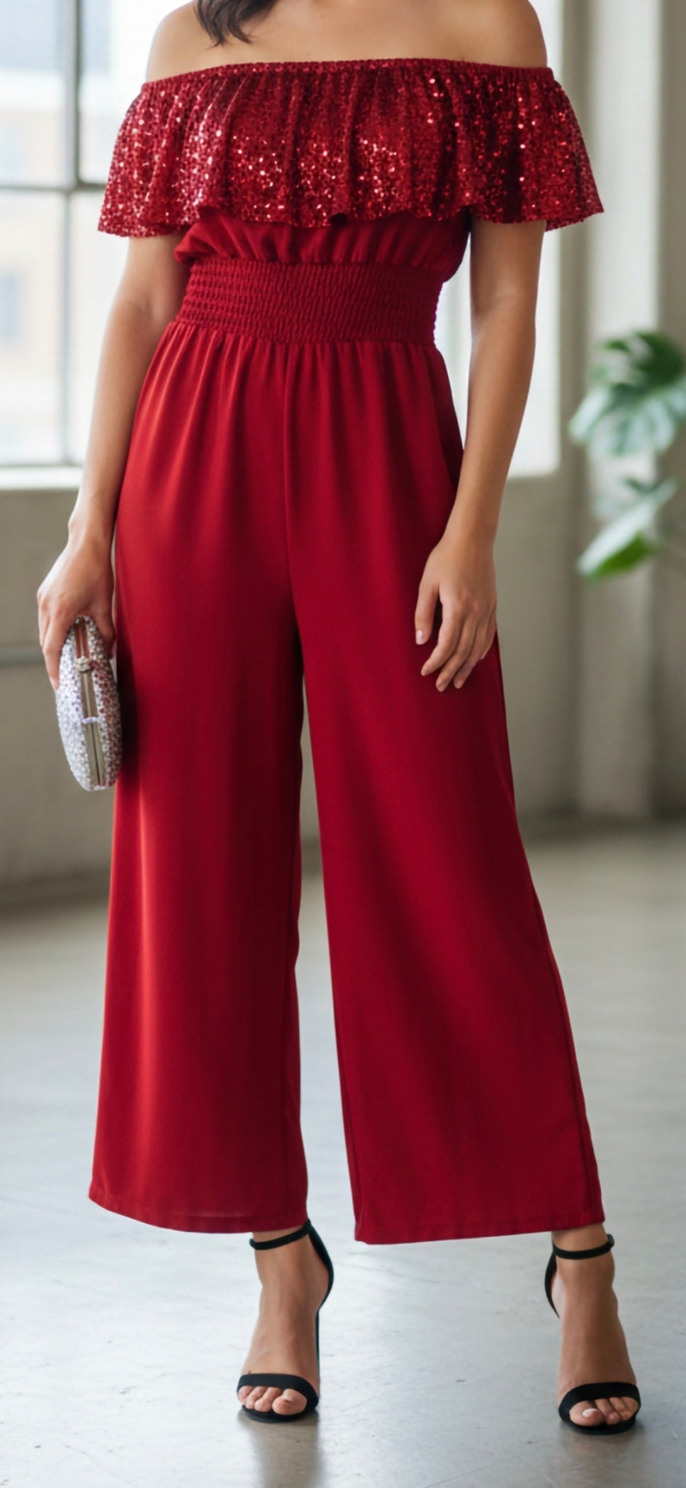 off-the-shoulder wide-leg jumpsuit with a sequin frill top and smocked waist
